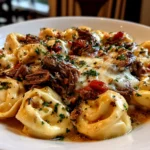 Beautiful Crock Pot Cheesesteak Tortellini served on white plate
